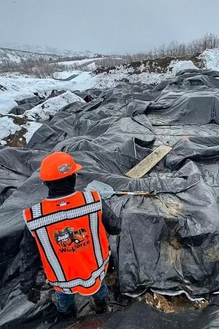 Workforce crew member in a hi-vis vest on a jobsite